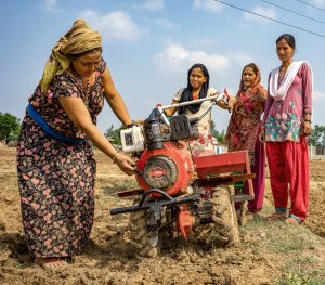 Women test a mini tiller for direct seeding of maize on farmland in Ramghat, Surkhet district, Nepal.